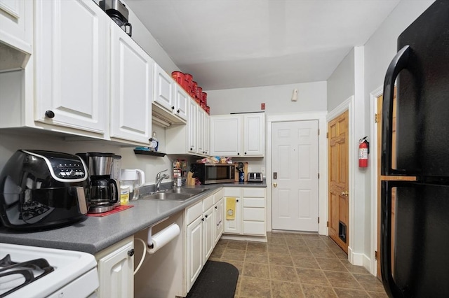 186 Summit St, Pawtucket, RI 02860 - kitchen with freestanding refrigerator, a sink, dishwashing machine, white cabinetry, and stainless steel microwave