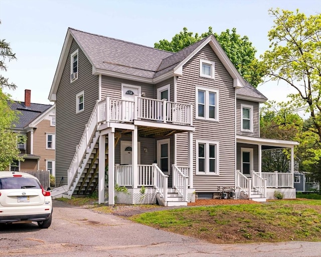 12 Cross St, Pepperell, MA 01463 - view of front facade featuring a shingled roof, a porch, and stairway