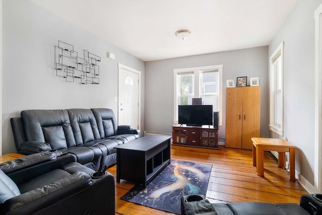 12 Cross St, Pepperell, MA 01463 - living area with wood-type flooring and a baseboard heating unit