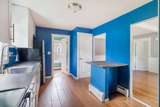 12 Cross St, Pepperell, MA 01463 - kitchen featuring a sink, baseboard heating, and light wood-type flooring