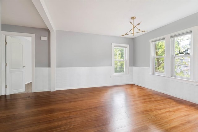 12 Cross St, Pepperell, MA 01463 - spare room featuring wood finished floors, a chandelier, and wainscoting