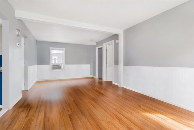12 Cross St, Pepperell, MA 01463 - empty room with light wood-style flooring, cooling unit, beam ceiling, and baseboards