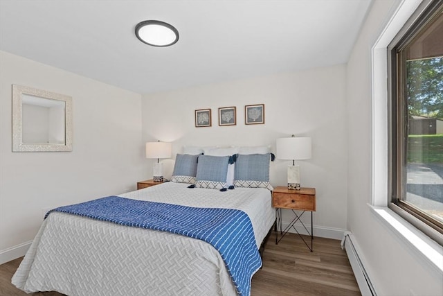 29 Adams Ct Unit 29, Amesbury, MA 01913 - bedroom with a baseboard radiator, wood finished floors, and baseboards
