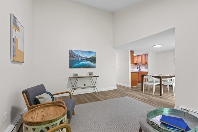 29 Adams Ct Unit 29, Amesbury, MA 01913 - living room with a baseboard heating unit, wood finished floors, and baseboards