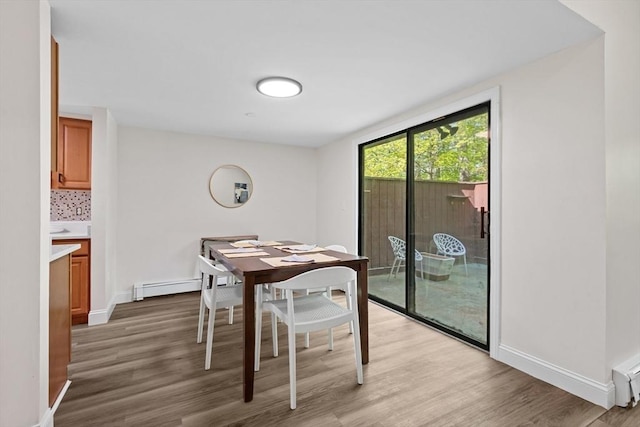 29 Adams Ct Unit 29, Amesbury, MA 01913 - dining space featuring a baseboard heating unit, light wood-style flooring, and baseboards
