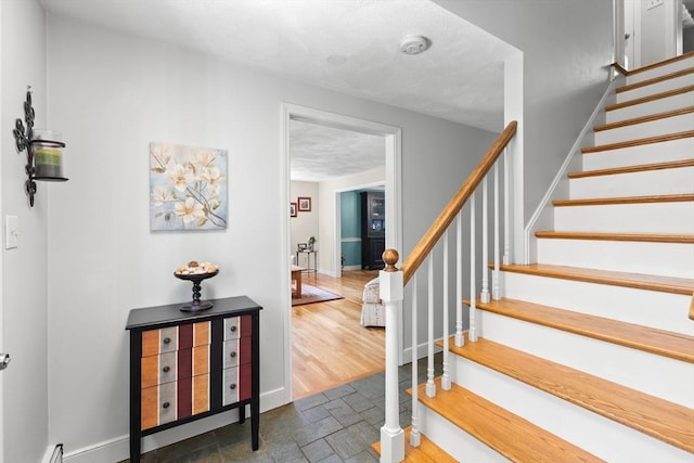 1005 Forest St, North Andover, MA 01845 - staircase featuring baseboards, stone finish floors, and a baseboard radiator