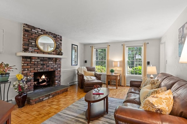 1005 Forest St, North Andover, MA 01845 - living area featuring baseboard heating, a fireplace, and a wainscoted wall