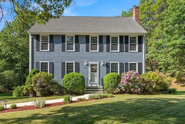 1005 Forest St, North Andover, MA 01845 - colonial home featuring a chimney and a front lawn