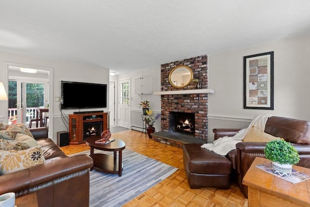 1005 Forest St, North Andover, MA 01845 - living area with a brick fireplace, a wainscoted wall, a baseboard radiator, and a textured ceiling