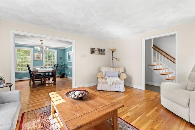 1005 Forest St, North Andover, MA 01845 - living area with a chandelier, light wood-style floors, stairs, and baseboards