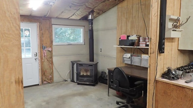 interior space with wood walls and a wood stove