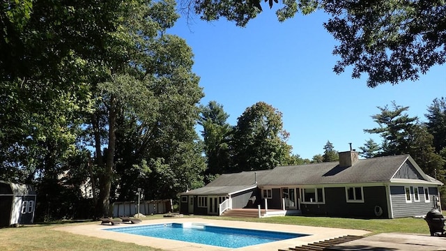 view of pool featuring a yard and a patio