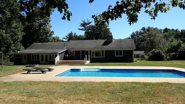 view of swimming pool featuring a lawn and a patio