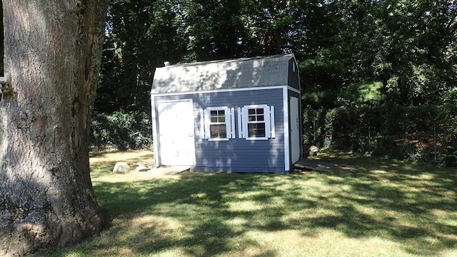 view of outbuilding with a lawn