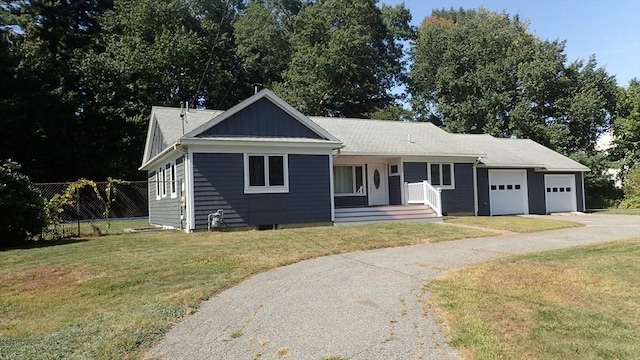 view of front facade with a garage and a front lawn