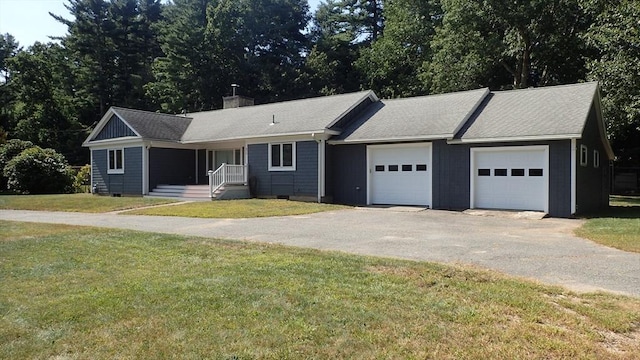 single story home featuring a garage and a front lawn