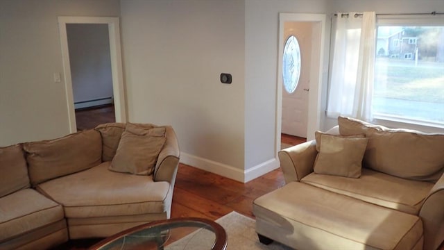 living room featuring a baseboard radiator and light hardwood / wood-style floors