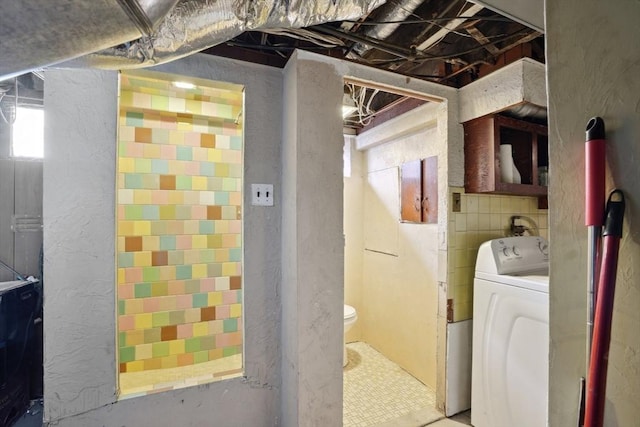 laundry area featuring washer / clothes dryer, laundry area, and a textured wall