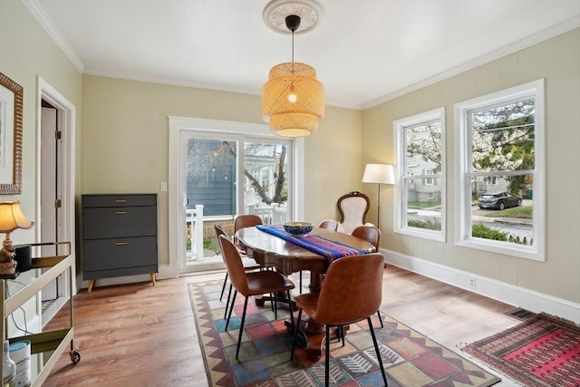 dining area with visible vents, ornamental molding, and light wood-style floors