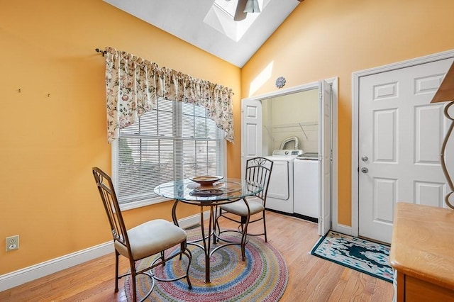 75 Orchard Meadow Dr Unit 75, Shrewsbury, MA 01545 - dining area with washer and dryer, vaulted ceiling with skylight, baseboards, and light wood-type flooring