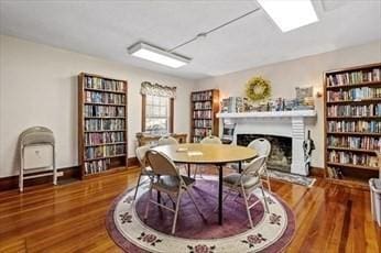 75 Orchard Meadow Dr Unit 75, Shrewsbury, MA 01545 - dining space featuring a fireplace and wood finished floors