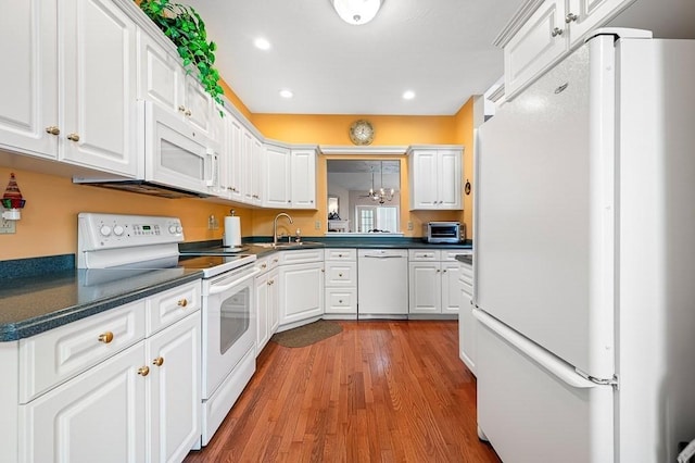75 Orchard Meadow Dr Unit 75, Shrewsbury, MA 01545 - kitchen featuring white appliances, dark countertops, wood finished floors, and white cabinetry