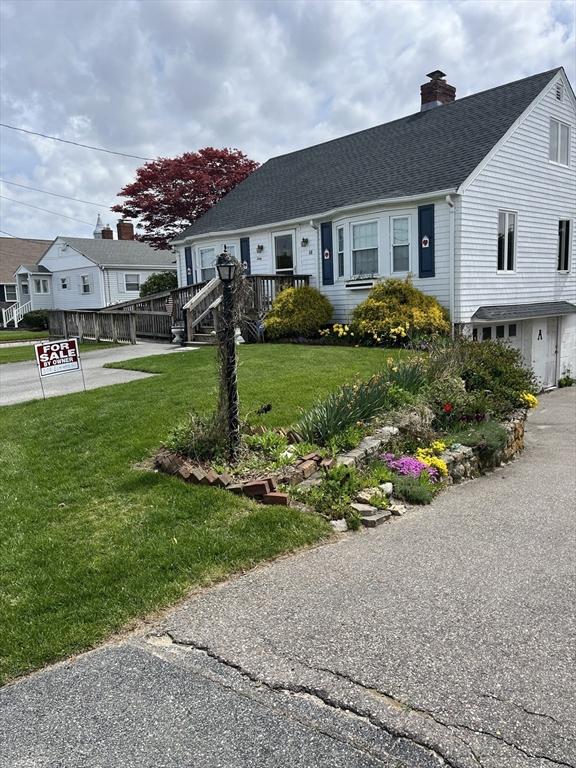 60 Academy Dr, Bourne, MA 02532 - view of front of property featuring roof with shingles, a chimney, and a front lawn