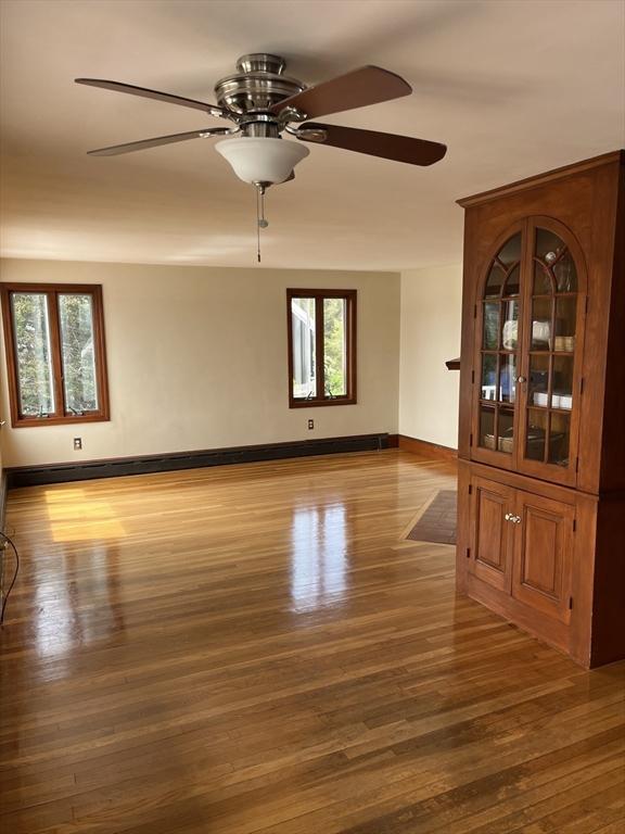 60 Academy Dr, Bourne, MA 02532 - spare room featuring wood finished floors, healthy amount of natural light, ceiling fan, and baseboards