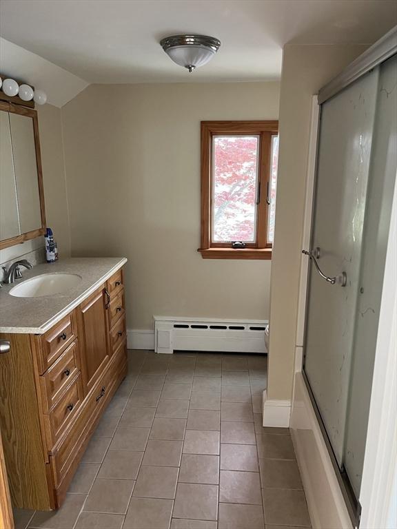 60 Academy Dr, Bourne, MA 02532 - full bathroom featuring an enclosed shower, baseboard heating, vanity, baseboards, and tile patterned flooring