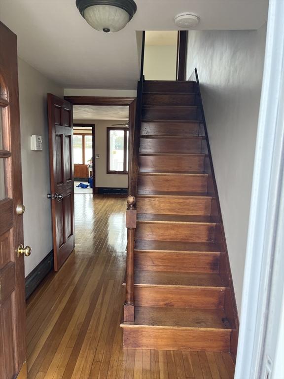 60 Academy Dr, Bourne, MA 02532 - staircase with hardwood / wood-style flooring and baseboards