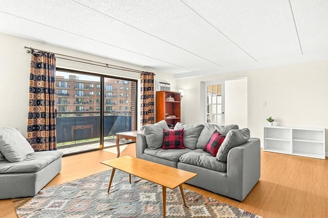 32 Whites Ave Unit F6605, Watertown, MA 02472 - living area with wood finished floors and a textured ceiling