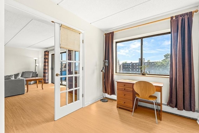 32 Whites Ave Unit F6605, Watertown, MA 02472 - office area with wood finished floors, a textured ceiling, and a baseboard radiator