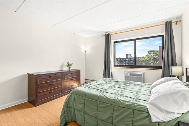 32 Whites Ave Unit F6605, Watertown, MA 02472 - bedroom with a wall unit AC and light wood-style flooring