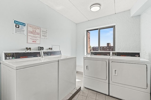 32 Whites Ave Unit F6605, Watertown, MA 02472 - communal laundry room featuring washing machine and dryer, a textured wall, and light tile patterned flooring
