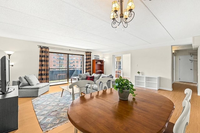 32 Whites Ave Unit F6605, Watertown, MA 02472 - dining room with light wood-style flooring and a chandelier