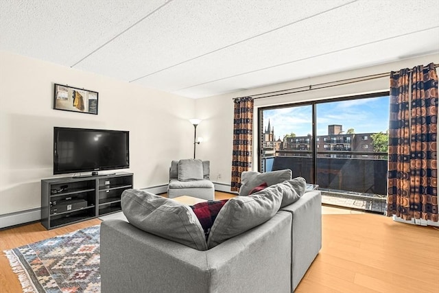 32 Whites Ave Unit F6605, Watertown, MA 02472 - living area with wood finished floors, a baseboard radiator, a city view, and a textured ceiling