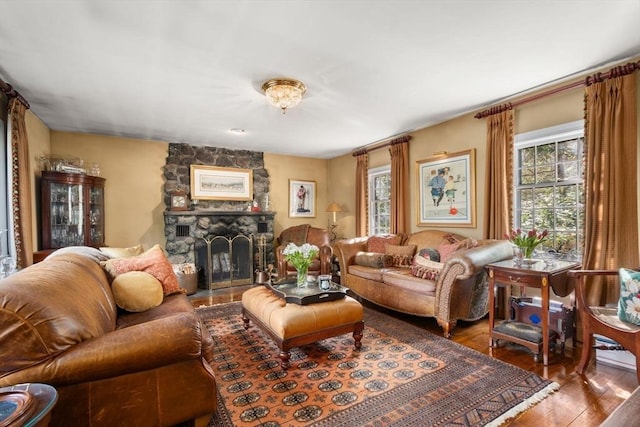 living area featuring hardwood / wood-style floors, a wealth of natural light, and a fireplace