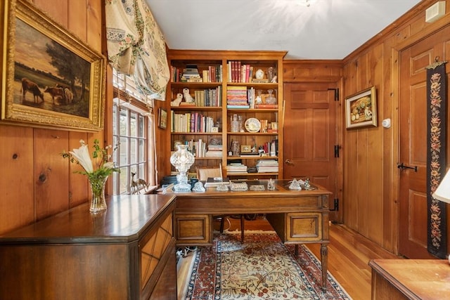 office space featuring visible vents, wood walls, and wood finished floors