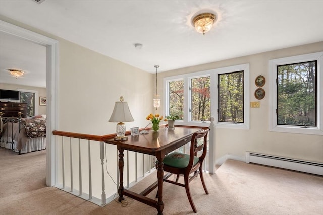 office featuring a baseboard radiator, a healthy amount of sunlight, and carpet flooring