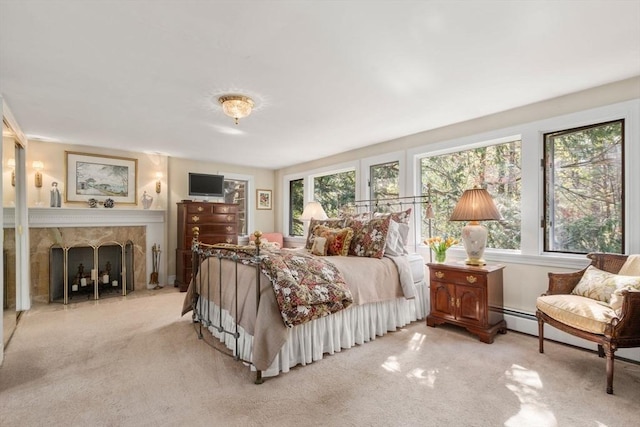 bedroom featuring a fireplace and light colored carpet