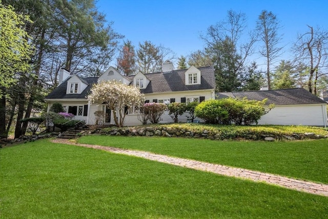 cape cod house with a front yard