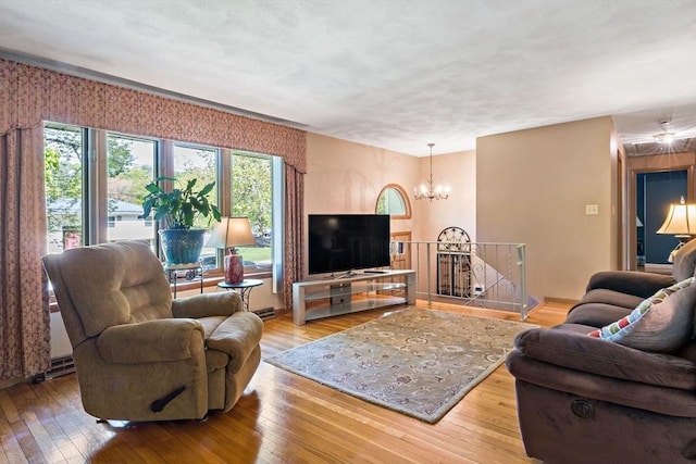 living area with a chandelier and wood-type flooring