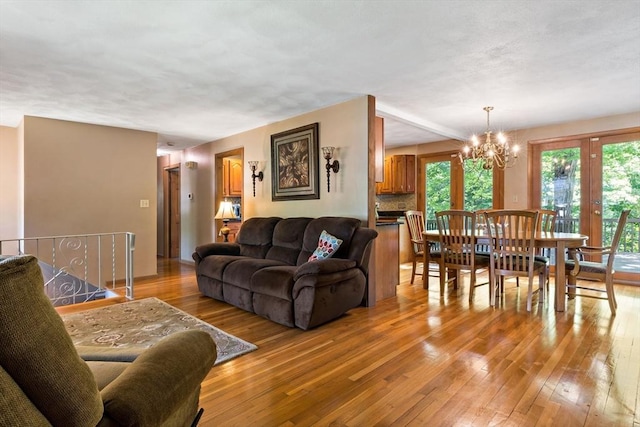 living area featuring light wood finished floors and a chandelier