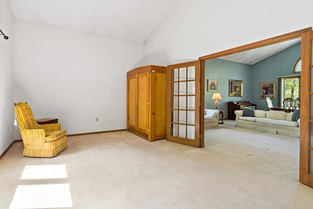 unfurnished room featuring vaulted ceiling, french doors, carpet flooring, and baseboards
