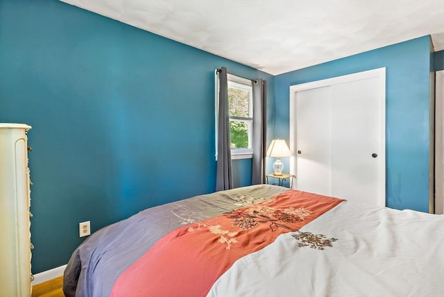 bedroom featuring a closet and baseboards