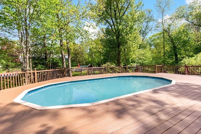 view of pool with a wooden deck