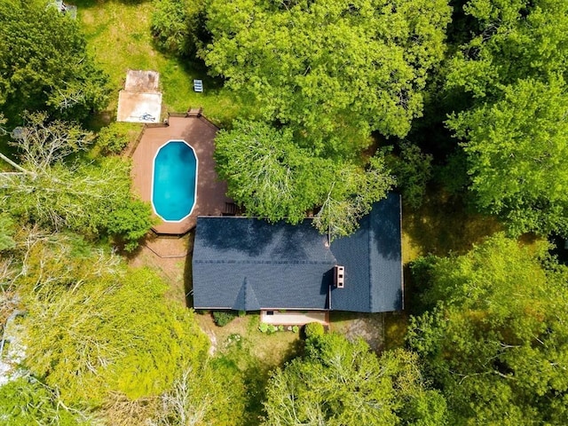view of subject property with a pool
