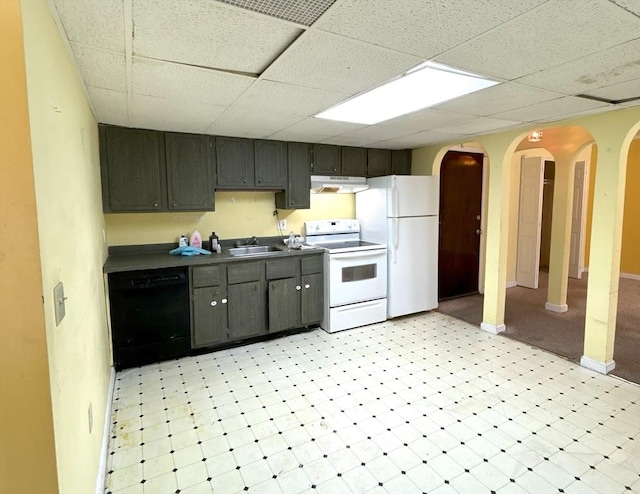 kitchen with arched walkways, a sink, a drop ceiling, white appliances, and extractor fan