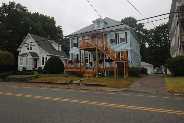 view of front of property featuring an outdoor structure and a garage