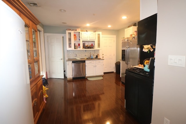 kitchen featuring dishwasher, white refrigerator, tasteful backsplash, black electric range, and dark hardwood / wood-style flooring